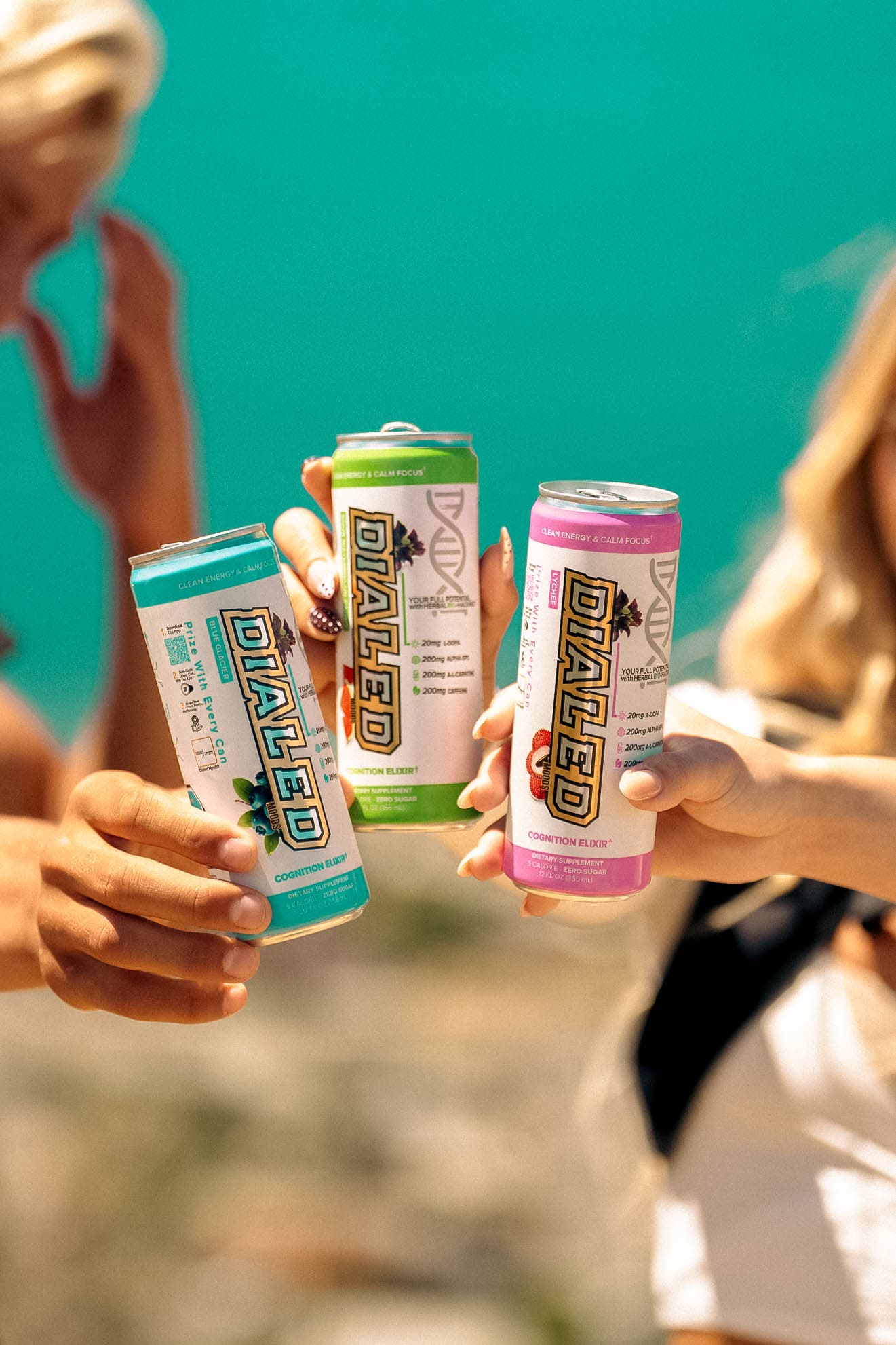 Three friends toasting with DIALED Cognition Elixir cans