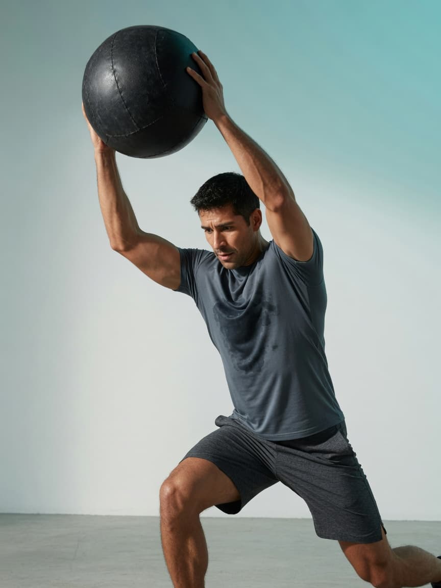 Man slamming a medicine ball in an open studio